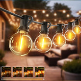 String of outdoor lights with glowing bulbs in a garden setting